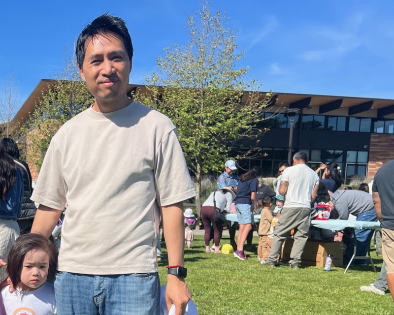 Bob Nguyen with his daughter at an egg hunt on the lawn of the Millbrae Community Center